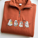 An orange fleece half-zip pullover sweatshirt featuring four cute cartoon ghosts reading books on the front, laid flat on a white background.