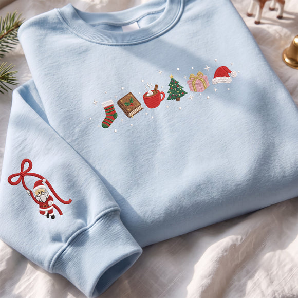 Light blue embroidered Christmas sweatshirt featuring holiday icons on the chest and a cute Santa Claus on the sleeve cuff.
