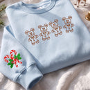 Light blue embroidered sweatshirt featuring brown Mickey Mouse gingerbread cookies on the chest and candy canes on the sleeve.