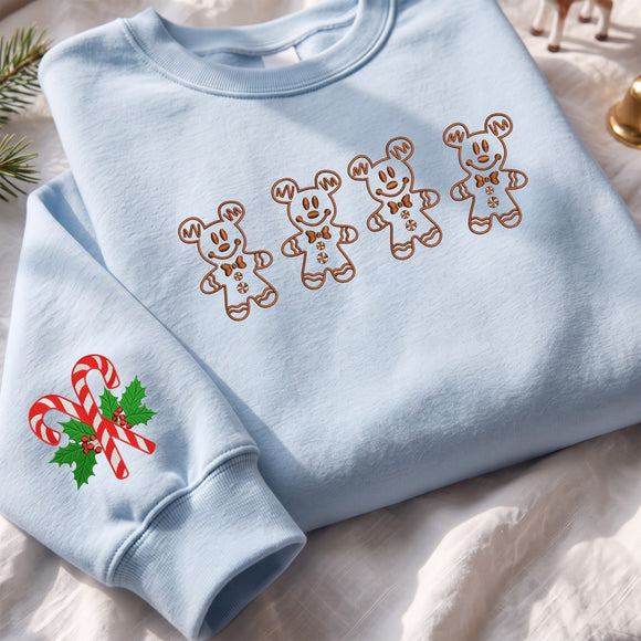 Light blue embroidered sweatshirt featuring brown Mickey Mouse gingerbread cookies on the chest and candy canes on the sleeve.