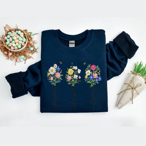 Navy blue sweatshirt with floral designs and text on a white background