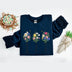 Navy blue sweatshirt with floral designs and text on a white background