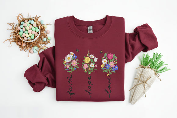 Light blue sweatshirt with floral designs and text on a white background