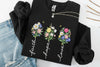 black sweatshirt with floral designs and text 'Faith', 'Hope', 'Love' on a white background.