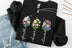 black sweatshirt with floral designs and text 'Faith', 'Hope', 'Love' on a white background.