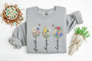 grey sweatshirt with floral designs and text on a white background