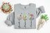 grey sweatshirt with floral designs and text on a white background
