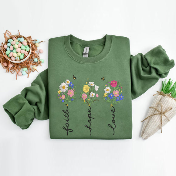 Green sweatshirt with floral designs and text on a white background